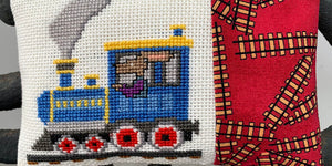 cross stitch design of a blue train with a rabbit engineer