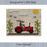 cross stitch design featuring a rabbit on a tractor between corn stalks